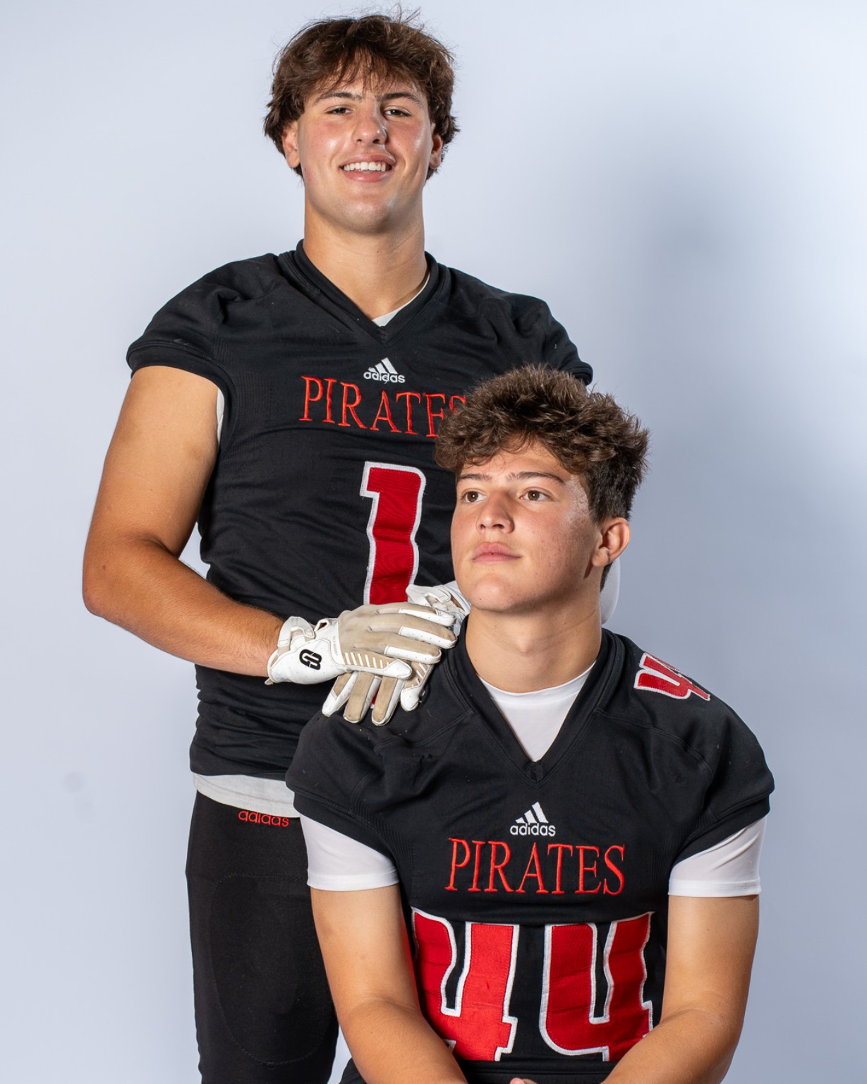 Two Cinnaminson Pirates football players posed in uniform