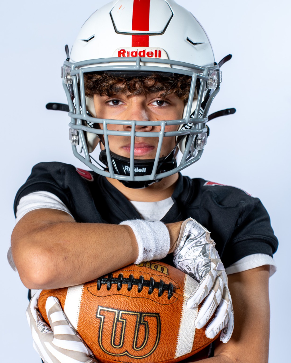 Cinnaminson Pirates football player in helmet holding a football